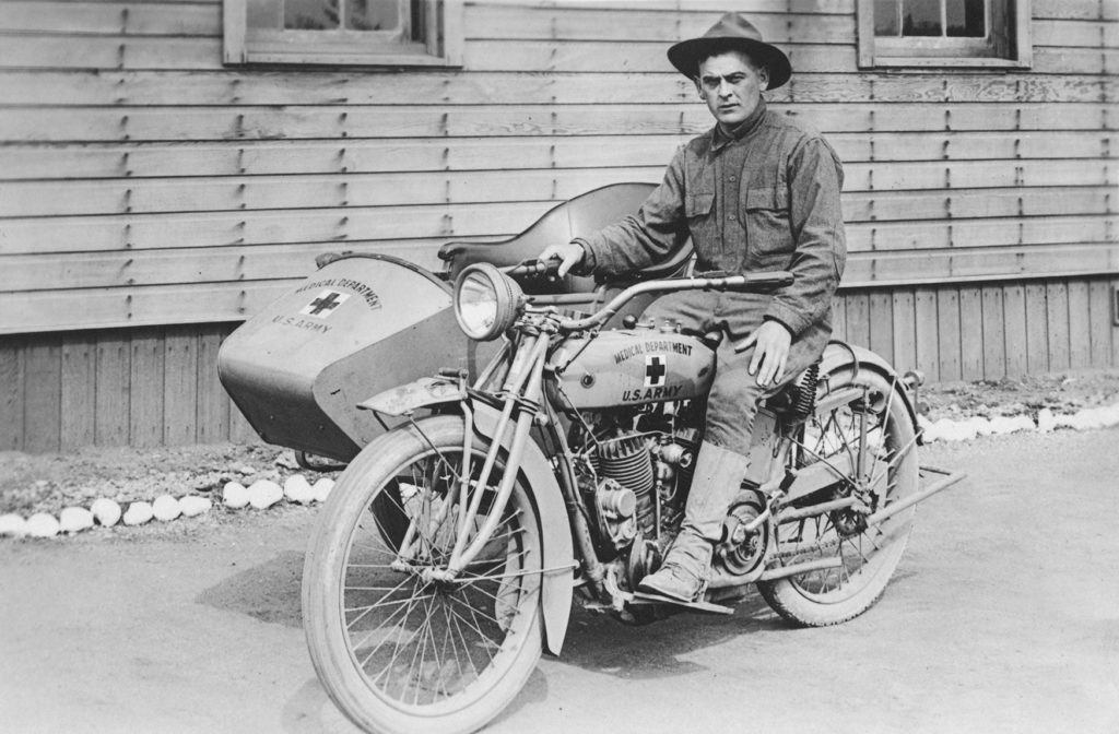 Private Henry M. Walsh poses on a motorcycle.